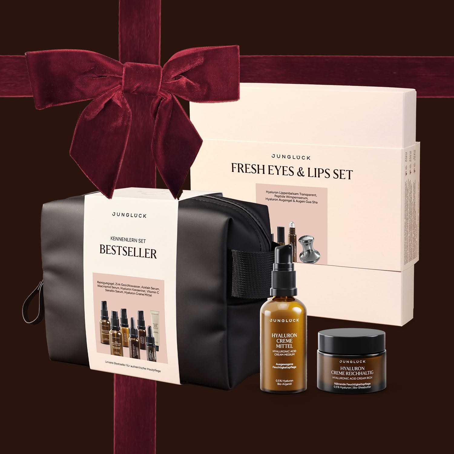 Geschenkset von JUNGLÜCK mit schwarz-weißer Kosmetiktasche, Hyaluron-Serum und Augencreme, umhüllt von einem roten