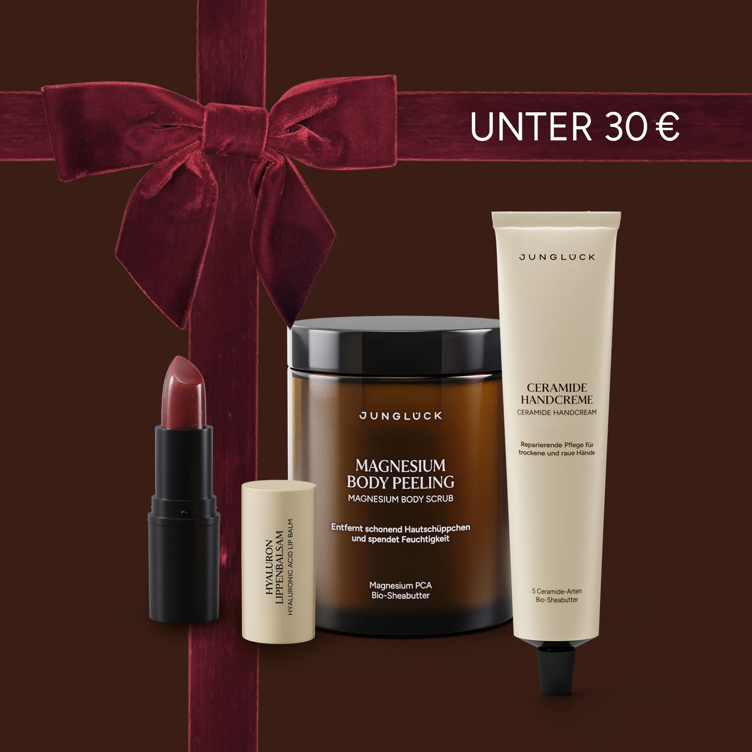 Geschenkset unter 30 € mit JUNGLÜCK Magnesium Body Peeling, Handcreme und Lippenpflege. Verpackt mit rotem Schleifenmotiv.