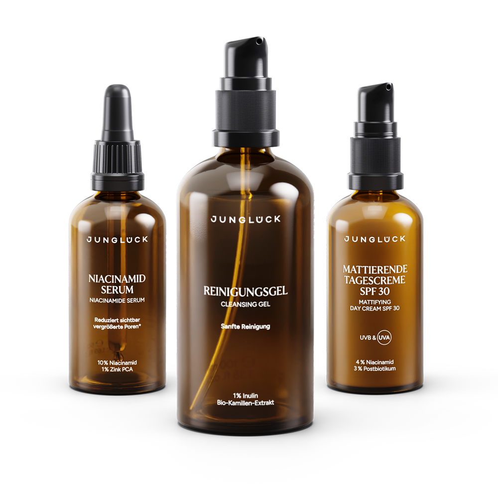 Set bestehend aus drei Braunglasflaschen: Niacinamid Serum, Reinigungsgel und mattierender Tagescreme SPF 30.