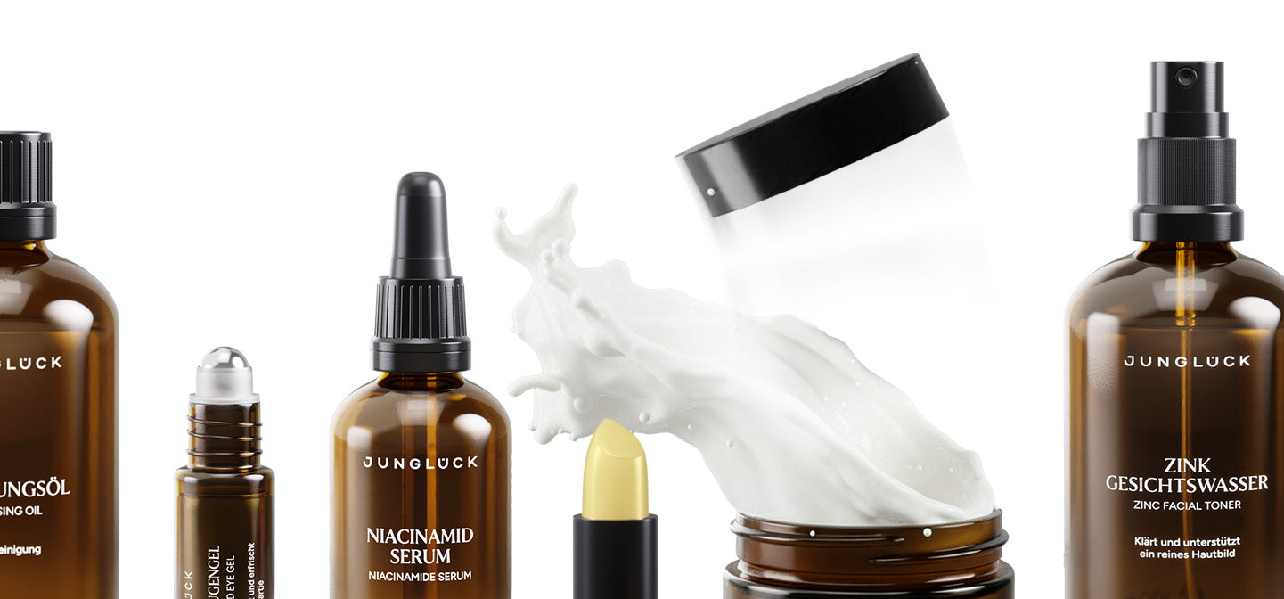 Braunglasflaschen mit verschiedenen Hautpflegeprodukten: Jungöl, Niacinamid Serum, Zink Gesichtswasser und eine Tube.